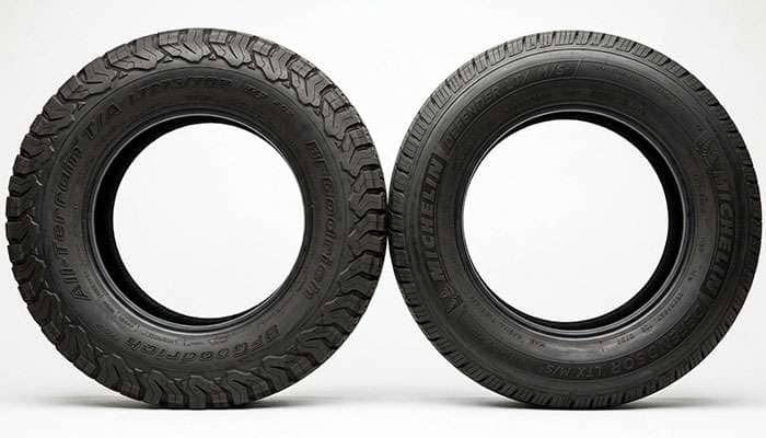 Close-up comparison of LT light truck tire sidewall and P-metric passenger tire sidewall showing load index markings