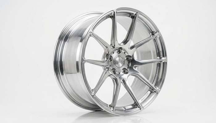 Forged billet aluminum wheel with machined spoke faces on a white studio backdrop