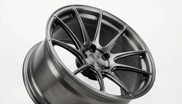 Close-up of a forged concave wheel barrel showing thin sculpted spokes and a deep recessed face