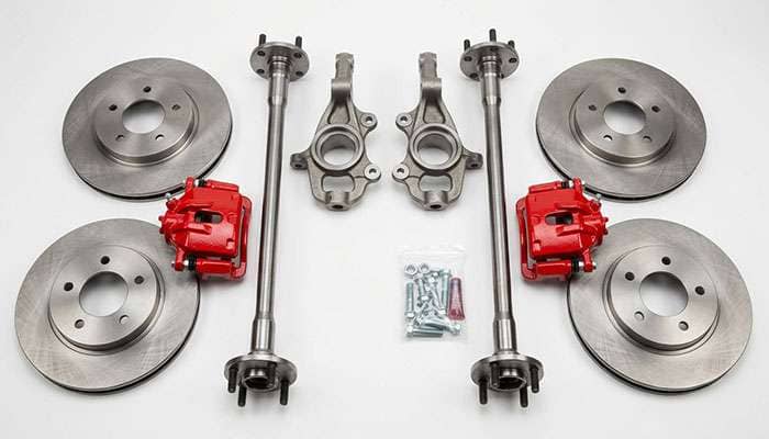 Fox body Mustang 5-lug conversion parts laid out including spindles, rotors, calipers and rear axle shafts