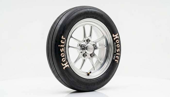 Narrow front runner drag racing tire mounted on a lightweight wheel