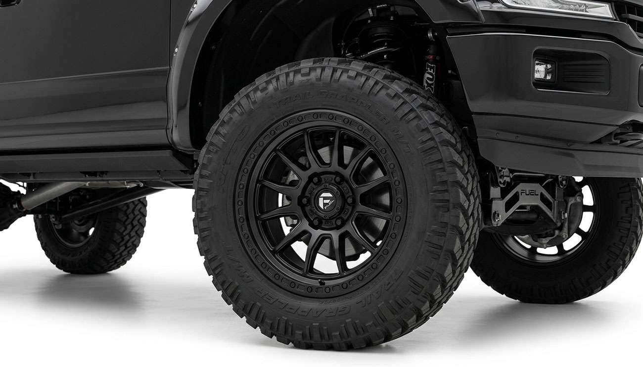 Fuel Rebel 6 wheel mounted on a lifted pickup truck showing the split spoke design and simulated beadlock ring