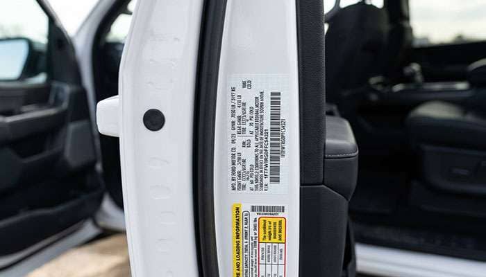 Vehicle certification label inside a truck door frame showing GVWR and front and rear GAWR figures