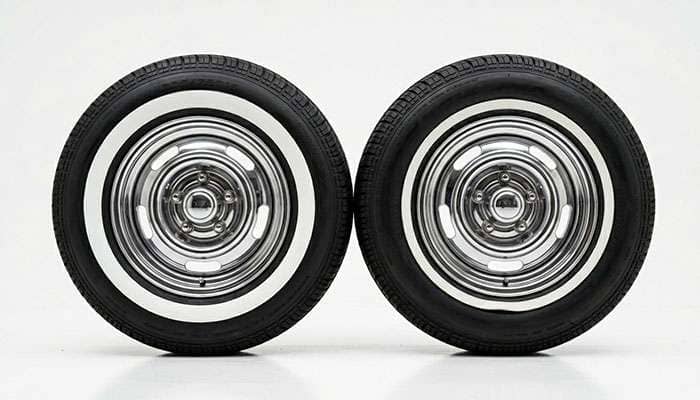 Side by side comparison of a genuine built-in whitewall tire and a portawall insert showing construction difference on a clean white surface