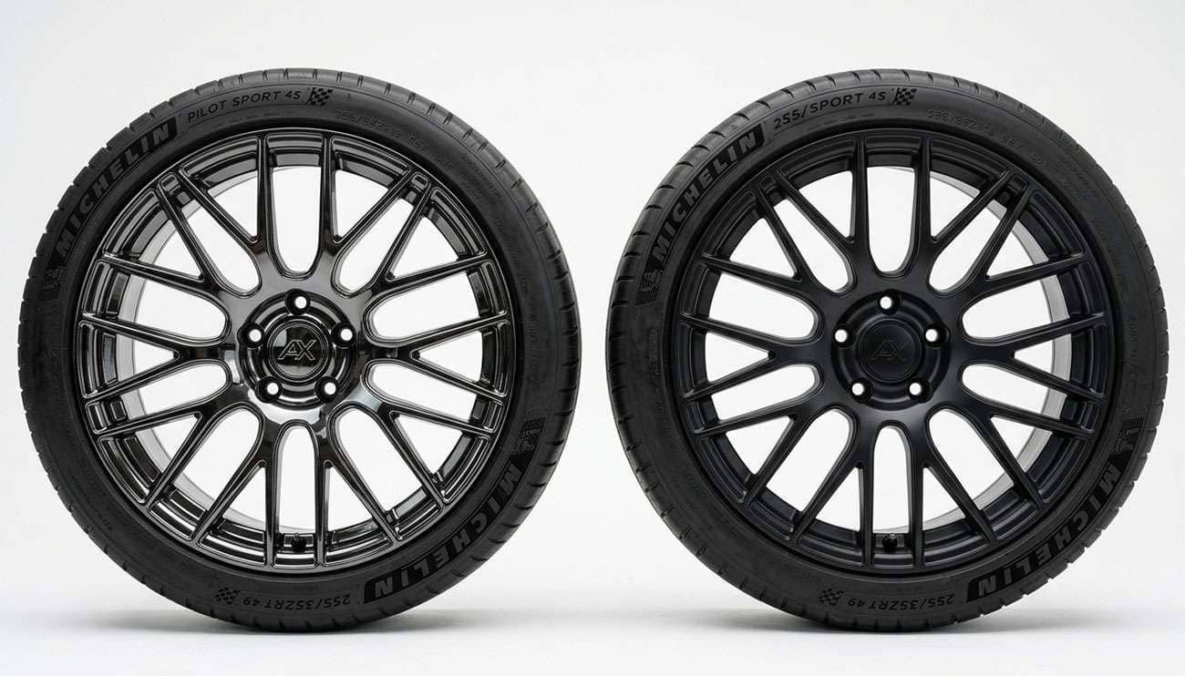 Glossy black alloy wheel and matte black alloy wheel positioned side by side showing the difference in light reflection