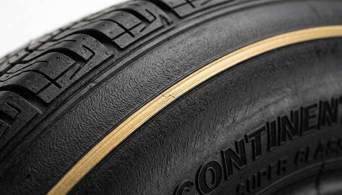 Close-up of the thin gold stripe molded into a classic tire sidewall