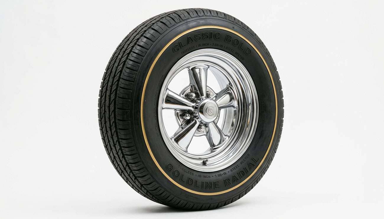Gold line tire with a thin gold stripe on the sidewall mounted on a classic chrome wheel against a clean white studio background