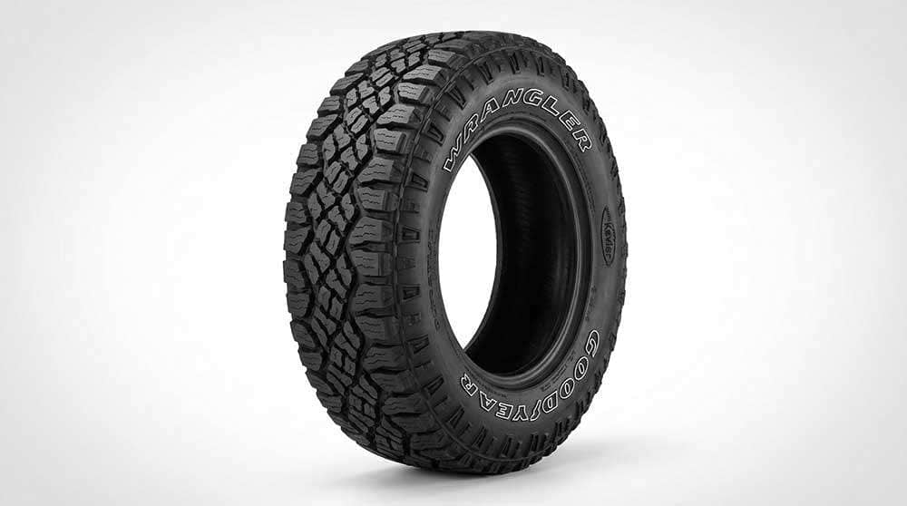 Close-up of a Goodyear Wrangler DuraTrac RT all-season all-terrain tire with deep tread and Kevlar branding