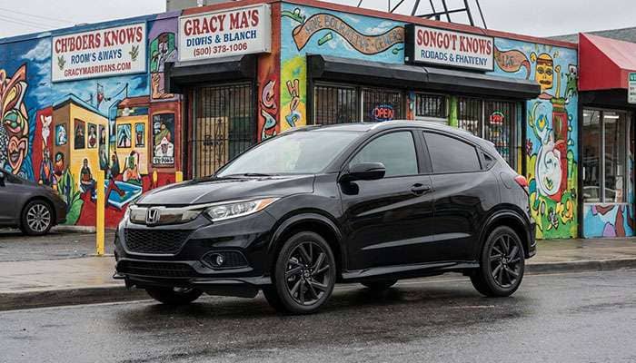 Black Honda HR-V with sport wheels parked in front of a colorful Shore Store on a cloudy day