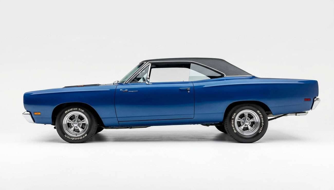 Classic American muscle car in profile with a nose-down forward rake stance