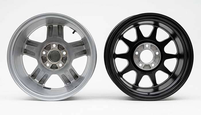 Side-by-side comparison of a high positive offset factory Jeep Gladiator wheel and a lower offset aftermarket 17 inch wheel showing backspacing difference