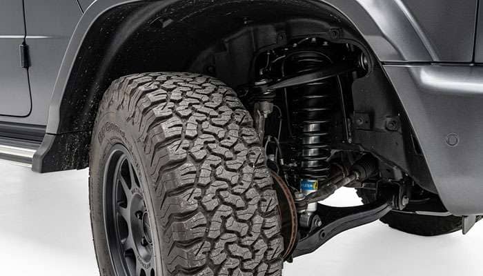 Close-up of the front inner fender liner clearance on a Jeep Wrangler JL with an oversize off-road tire at full steering lock