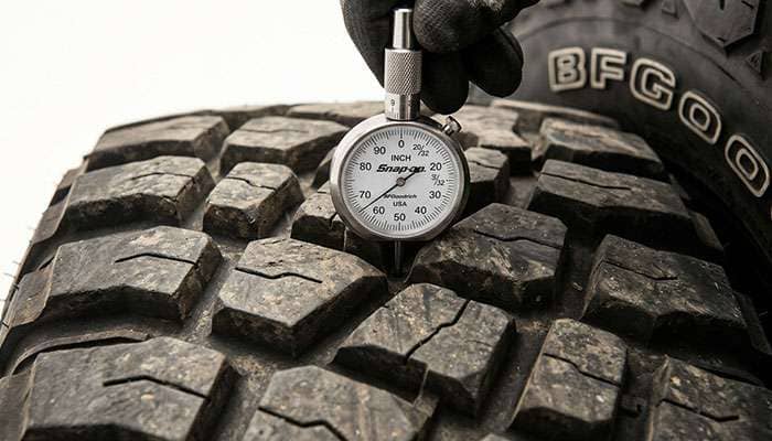 Tread depth gauge measuring the tread on a BFGoodrich Mud-Terrain T/A KM3 tire