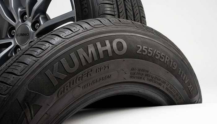 Close-up of a Kumho tire sidewall showing brand markings and size information