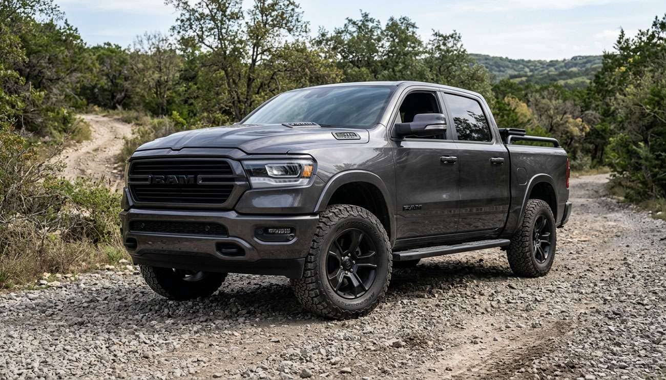 Leveled Ram 1500 pickup on 35-inch all-terrain tires parked on a gravel trail