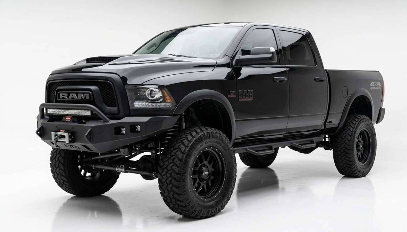 Lifted black 4x4 pickup truck with aggressive off-road tires showing fender clearance gap