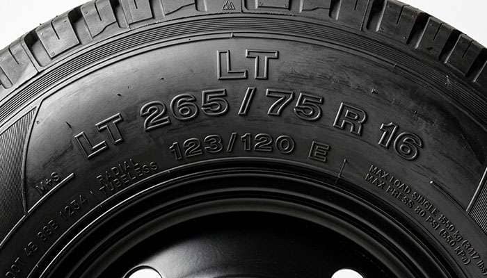 Light truck tire sidewall showing LT size designation, load index numbers and load range letter