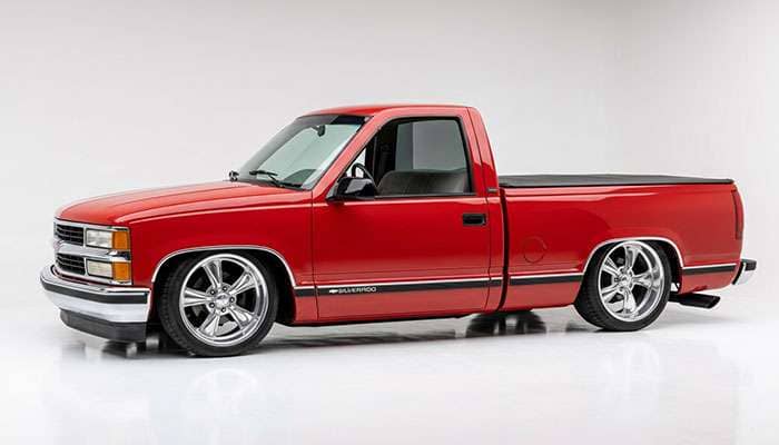 Lowered OBS Chevy C1500 regular cab pickup on 20 inch wheels with low profile tires tucked under the fenders