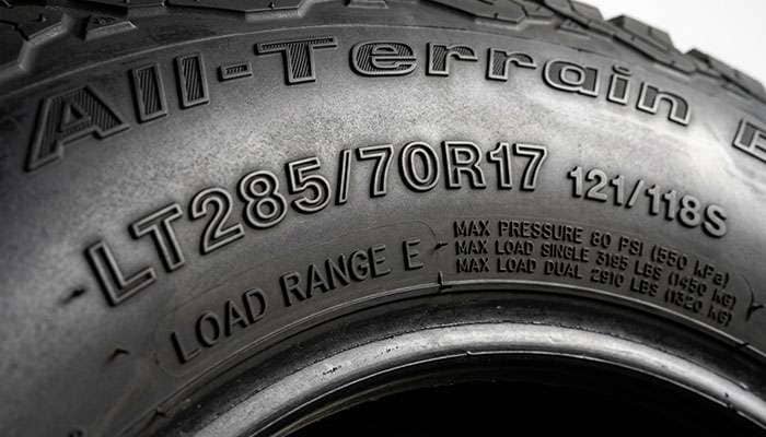Close-up of an LT285/70R17 tire sidewall showing the Load Range E marking, load index, and maximum pressure molding