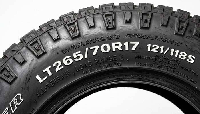 Close-up of an LT265/70R17 Load Range E all-terrain tire sidewall showing the load index and maximum inflation markings