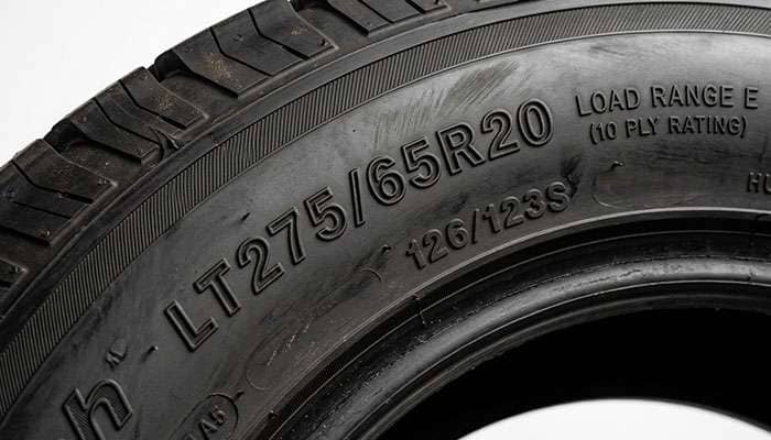 Close-up of LT275/65R20 sidewall showing the LT prefix, load index, and Load Range E marking