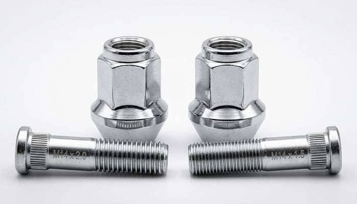 M14 x 2.0 and M14 x 1.5 conical-seat truck lug nuts side by side showing the coarser and finer thread pitch