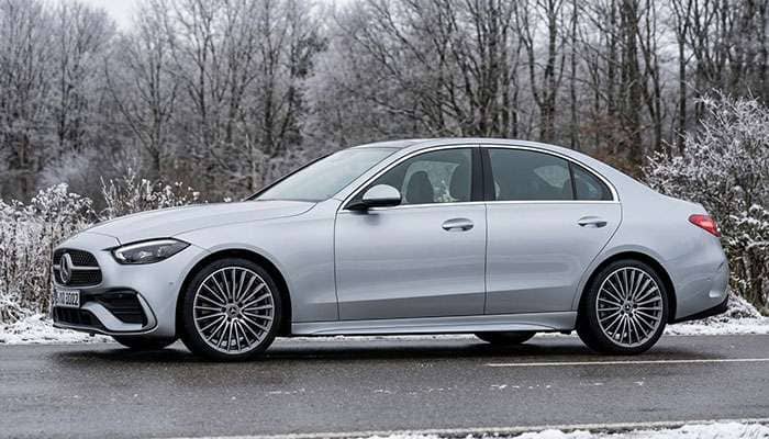 2022 Mercedes-Benz C-Class W206 sedan with camouflage on front and rear sections parked on a road in winter