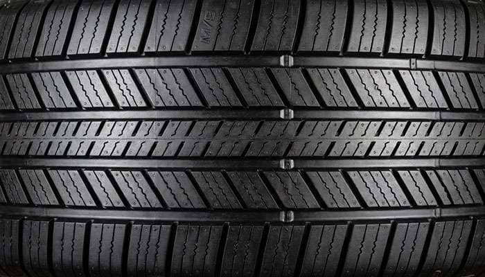 Close-up of Michelin Defender LTX MS tire tread designed for all-season traction and durability.