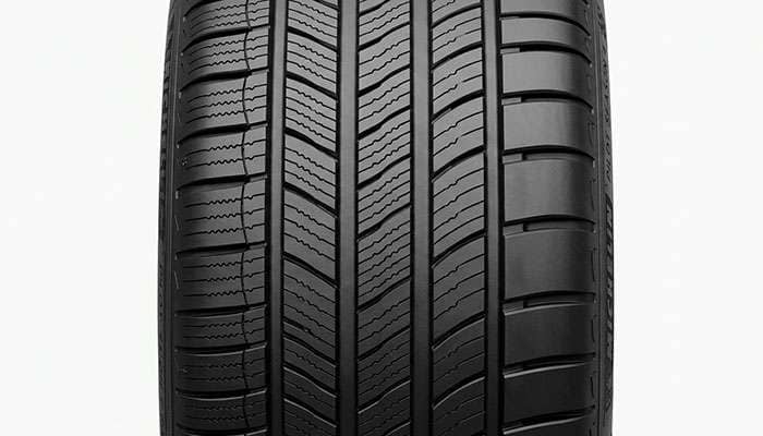 Close-up of Michelin Pilot Sport All Season 4 asymmetric tread showing full depth interlocking sipes and shoulder blocks