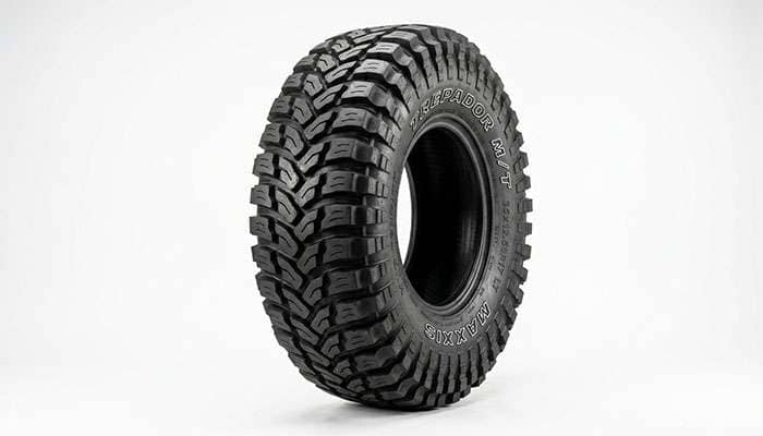 Mickey Thompson off-road tire with aggressive tread on a clean white seamless studio backdrop