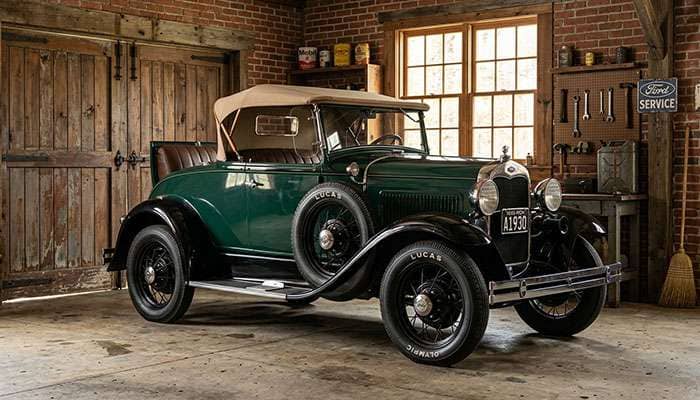 1930 Ford Model A roadster on Lucas Olympic blackwall 4.75/5.00-19 tires parked in a 1930s-era brick garage