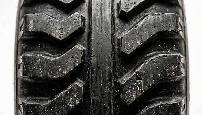 Close-up of NDT non-directional bar-grip tread with center strip and alternating cleats