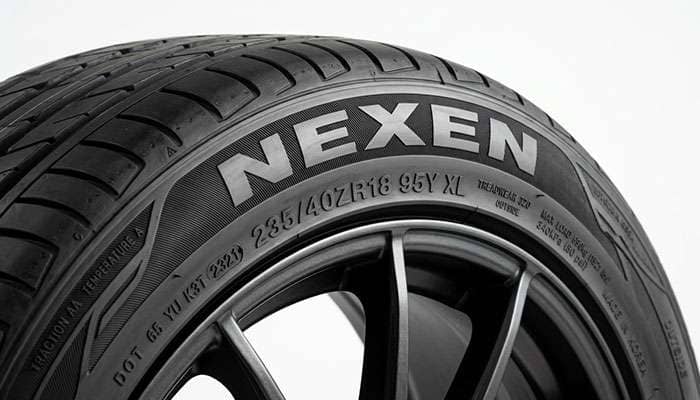 Close-up of a Nexen tire sidewall showing brand markings and tread detail