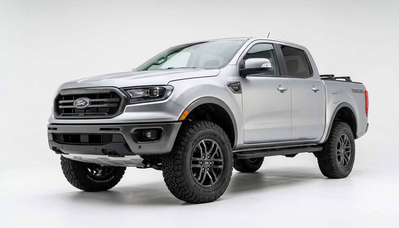 Nissan Frontier midsize pickup truck fitted with 33-inch all-terrain tires on six-lug wheels