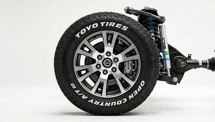 Close-up of a Nissan Titan XD wheel with Toyo Open Country tire on stock Pro-4X suspension.