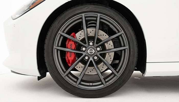 Close-up of Nissan Z wheel fitment showing brake caliper clearance and suspension components