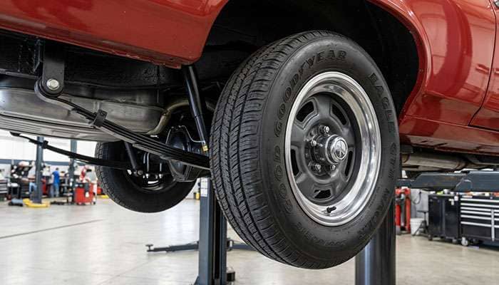 Rear wheelhouse of a 1968-74 Nova showing the leaf spring, rear tire, and quarter-panel lip clearance