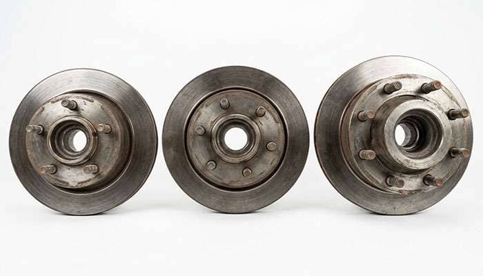 Three OBS Chevy truck wheel hubs side by side showing 5-lug, 6-lug, and 8-lug bolt patterns