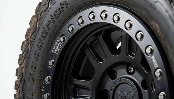 Close-up of an off-road beadlock wheel outer ring and bolt detail, studio product view