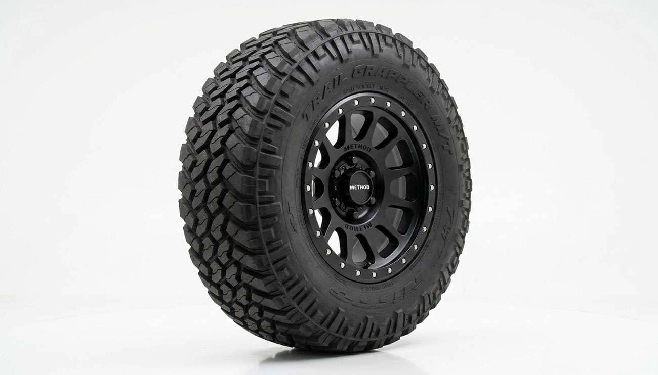 Oversized all-terrain tire mounted on a black off-road wheel