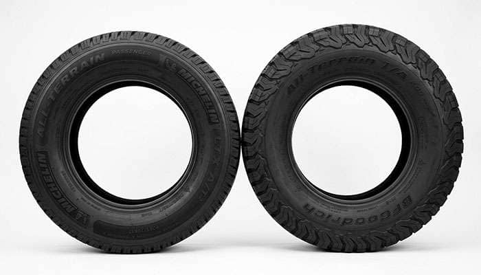 Passenger all-terrain tire and LT Load Range E all-terrain tire side by side showing sidewall markings
