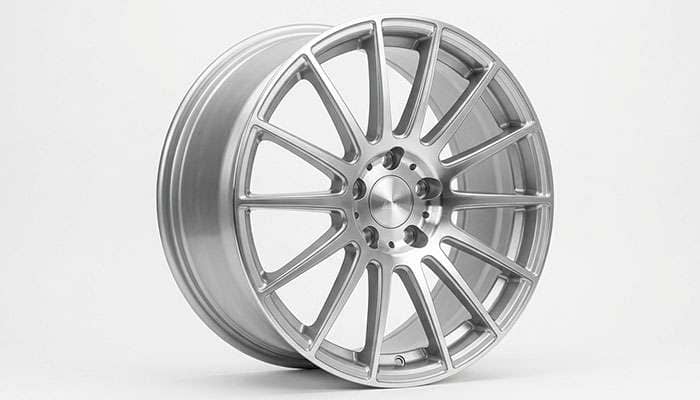 Close-up of a passenger car alloy wheel showing 5-lug bolt pattern and lightweight spoke design