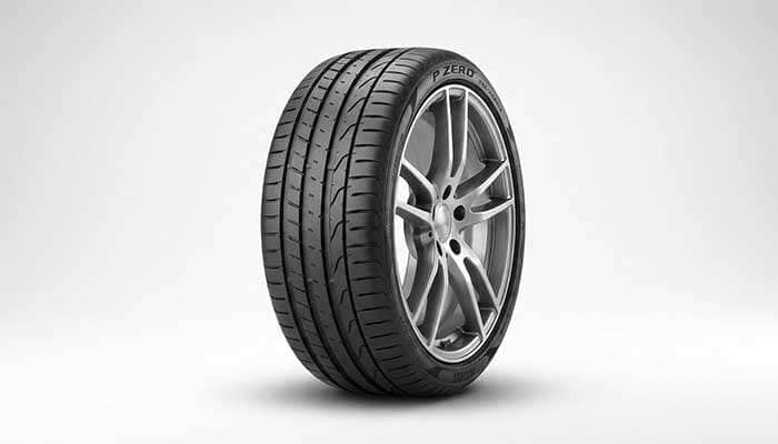Performance tire on sports car wheel showing low profile design and wide contact patch