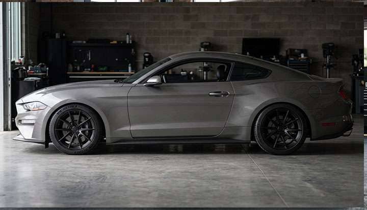 Detail of staggered pony car wheel and tire showing wider rear tire setup for traction