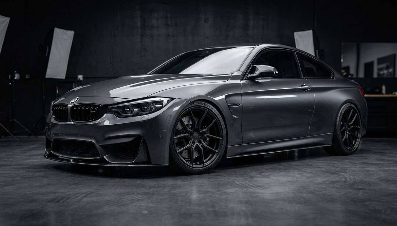 Freshly powder coated wheels in matte black finish on a sports car