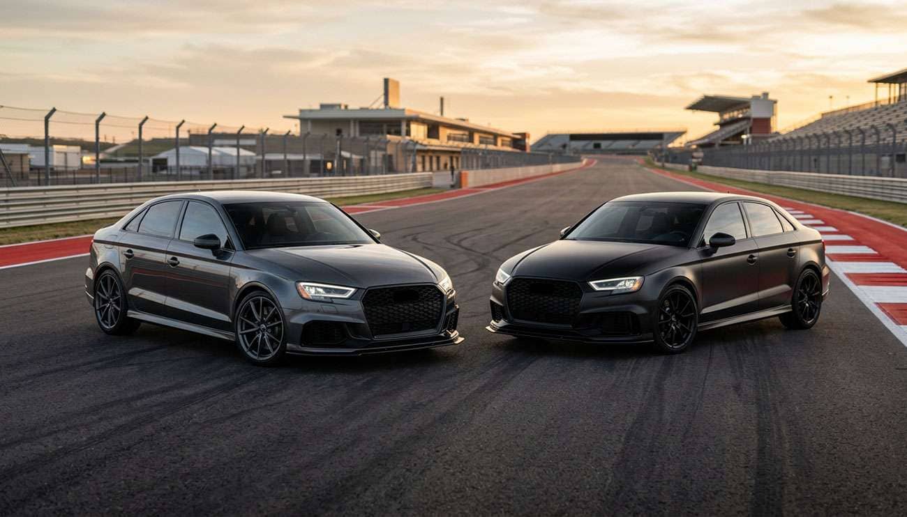 Two performance sedans at a race track for ultra-high-performance tire comparison