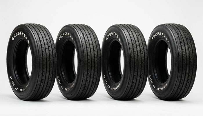 Set of raised white letter muscle car tires with vintage tread standing upright