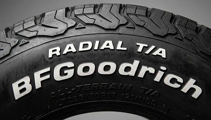 Close-up view of raised white letter tire sidewall showing the bold white vulcanized lettering proud of the tire surface