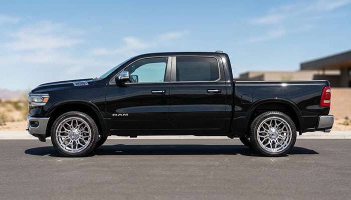 2023 black Dodge RAM 1500 truck with 20' chrome Fuel Wheels FC402PB under clear blue sky