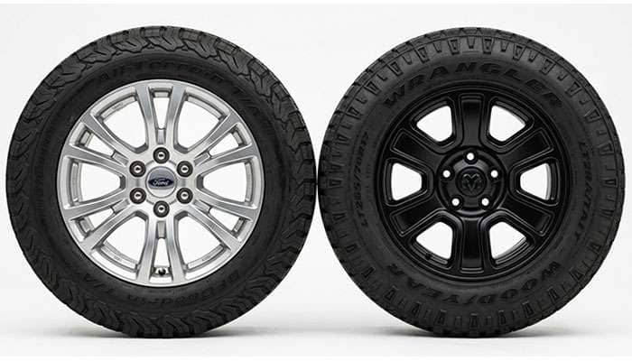 Six-lug Ram 1500 DT truck wheel beside a five-lug Ram 1500 Classic truck wheel